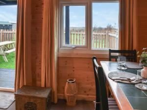 a dining room with a table and a window at Algwen Cabin 