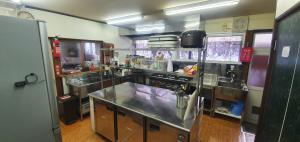 a kitchen with two sinks and a stainless steel counter at snowhere ski lodge in Hakuba +52 photos