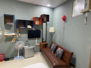 a living room with a couch and a tv at Luyu Homestay in Lukang