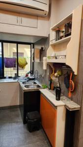 a small kitchen with a sink and a counter at ApartOfCalcutta! in Kolkata