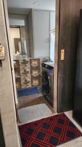 a kitchen with a washer and dryer in a room at ApartOfCalcutta! in Kolkata