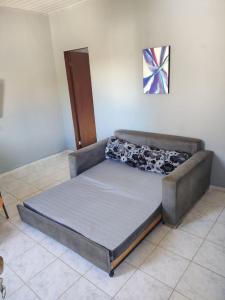 a bed sitting in a room with at SÃO PEDRO DA ALDEIA À 15 MINUTOS DE CABO FRIO in São Pedro da Aldeia