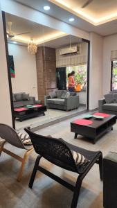 a living room with a couch and a table and chairs at ApartOfCalcutta! in Kolkata