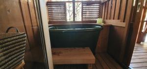 a bath tub in a room with a window at snowhere ski lodge in Hakuba