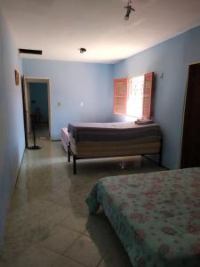 a bedroom with two beds and a window at Casa de praia in Luis Correia