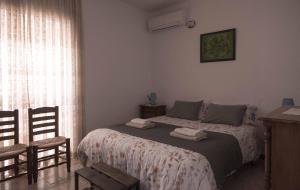 - une chambre avec un lit, une table et des chaises dans l'établissement Vista Castillo Apartments, à Alora