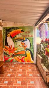 a wall with a painting of a bird on it at Hotel Arqueológico San Agustín in San Agustín