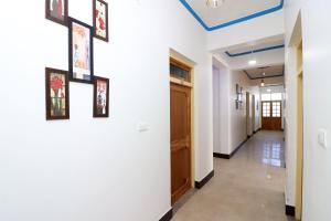 a hallway with white walls and a blue ceiling at OYO Flagship Hotel Ratnodaya in Almora