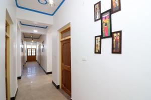 a hallway in a house with paintings on the wall at OYO Flagship Hotel Ratnodaya in Almora