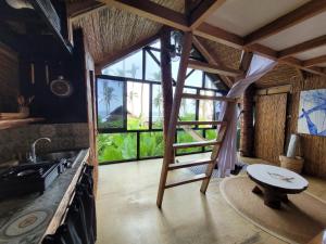 a kitchen with a ladder in the middle of a room at Tarzan's House in General Luna +142 photos