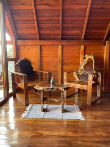 pokój ze stołem i ławką w pokoju w obiekcie Cabañas la Miranda w mieście Filandia