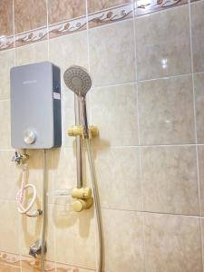 a shower with a shower head in a bathroom at Bayu View Hotel Klang in Klang