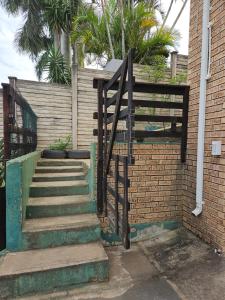 a set of stairs next to a brick wall at Kiaatplace Holiday Apartment in Kingsburgh