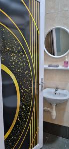 a bathroom with a door with a painting of a moon at CH Homestay Tanah Rata, Cameron Highlands, Keyless Entry in Tanah Rata