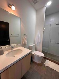 a bathroom with a sink and a toilet at New Modern Apartment near Mall in Guatemala