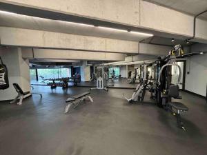 a gym with several treadmills and machines in it at New Modern Apartment near Mall in Guatemala