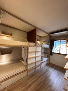 a room with several bunk beds in it with a window at Terminal58hostel@town in Ban Lo Long