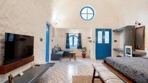 a bedroom with a bed and a blue door at Aphrodite Homestays Coorg by The Almanac in Napoklu