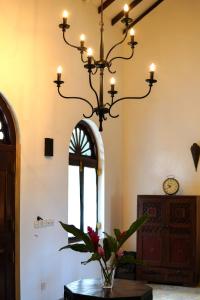 a chandelier hanging in a room with a table at Fort Bliss in Galle