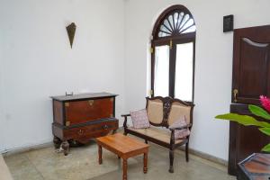 a room with two chairs and a cabinet and a table at Fort Bliss in Galle