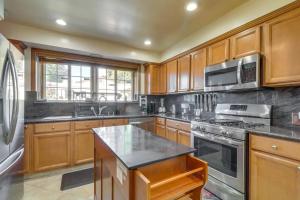 a kitchen with wooden cabinets and stainless steel appliances at Luxury Oasis Home w/Pool Near CSUN-6 Guests in North Hills