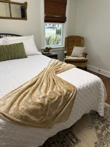 a bedroom with a bed with a blanket on it at Crabapple Cottage in Hesston +3 photos