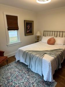 a bedroom with a bed with a pillow on it at Crabapple Cottage in Hesston