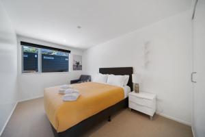 a bedroom with a large bed and a window at Blackrock Apartments Queenstown in Queenstown