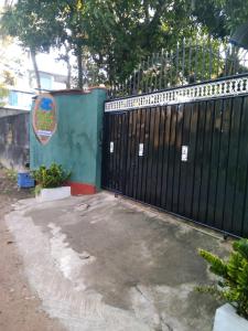 a black gate in front of a building at Koala Homestay in Weligama