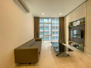 a living room with a couch and a television at PLATINUM Suites KLCC By AR Hospitality in Kuala Lumpur