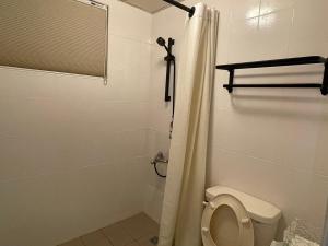 a white bathroom with a toilet and a shower at 埔里北梅民宿BEI MEI Homestay可包棟 in Puli