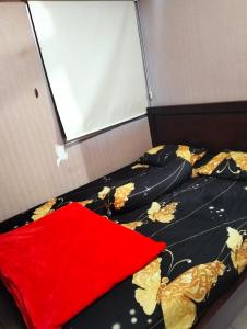 a bedroom with two beds with a black and gold blanket at Apartemen Kalibata City By Diamond Property in Jakarta