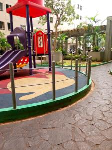 a playground with a slide in a park at Apartemen Kalibata City By Diamond Property in Jakarta
