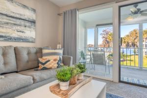 a living room with a couch and sliding glass doors at River Bend B212 in Welaka