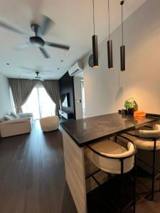 eine Küche und ein Wohnzimmer mit einem Deckenventilator in der Unterkunft Datum KLCC Sky Ring Linked To LRT & Mall by AwNa in Kuala Lumpur