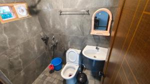 a small bathroom with a toilet and a sink at SARAS HOME ALAPPUZHA BEACH in Alleppey