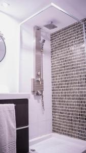 a bathroom with a shower with a sink and a shower at apartment next to park guell in Barcelona