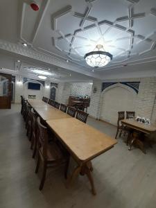 a large dining room with wooden tables and chairs at Amina Hotel boutique in Bukhara