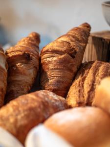 een stapel croissants en brood op een tafel bij AURA Bed & Breakfast in Sankt Jakob in Defereggen