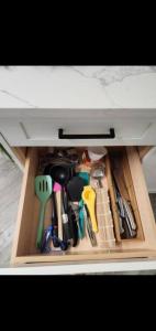 a drawer filled withrenches and other kitchen utensils at Cozy in Regina