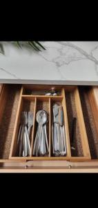 a drawer filled with utensils in a cabinet at Cozy in Regina