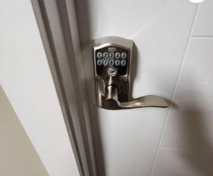 a doorhandle to a bathroom door with a door knob at Like Home in Regina