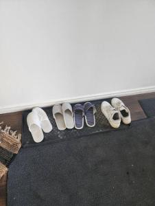 a row of four pairs of shoes on a shelf at Like Home in Regina