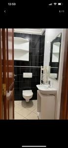 a bathroom with a sink and a toilet and a mirror at Duplex corniche lac 2 in Tunis