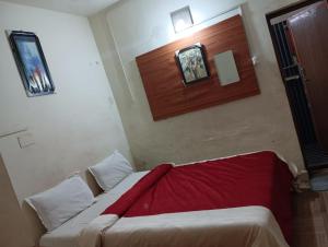 a bedroom with a bed with a red blanket on it at FLGHR Crazy Home Stay in Kodaikānāl