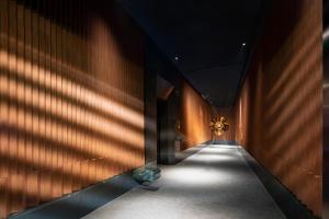 a hallway with shadows on the wall of a building at W Suzhou - Jinji Lake in Suzhou