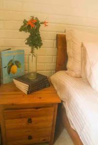 a bedroom with a bed and a table with a vase with flowers at Best Kept Secret by the Sea in Famagusta
