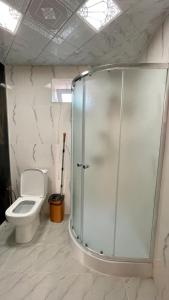 a bathroom with a toilet and a glass shower at AkbA-Frame3 in İsmayıllı