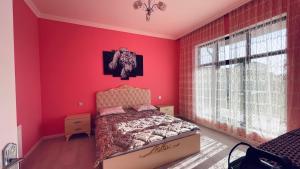 a bedroom with red walls and a bed in it at AkbA-Frame3 in İsmayıllı