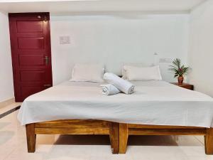 Postel nebo postele na pokoji v ubytování Varkala Villa